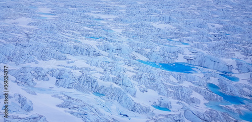 Wide aerial of glacier in greenland with glacial rivers and lakes