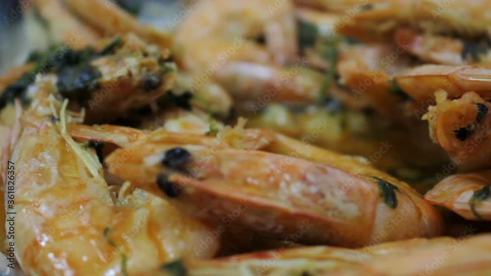 Hand taking one delicious and hot Fried prawnn