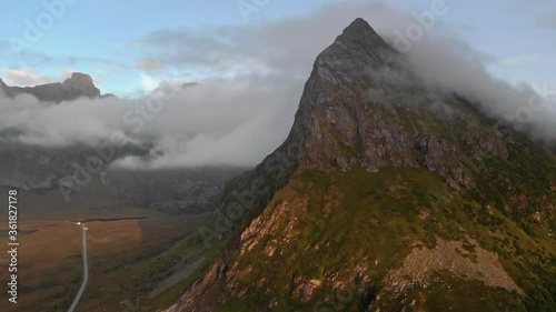 High peak near Fredvang Bridges, Fredvangbruene, are two cantilever bridges at dusk in Lofoten, Norway. photo