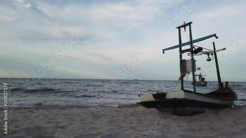 Small boats on the beach at the sea, Thailand, people are playing in the sea, copy space at left