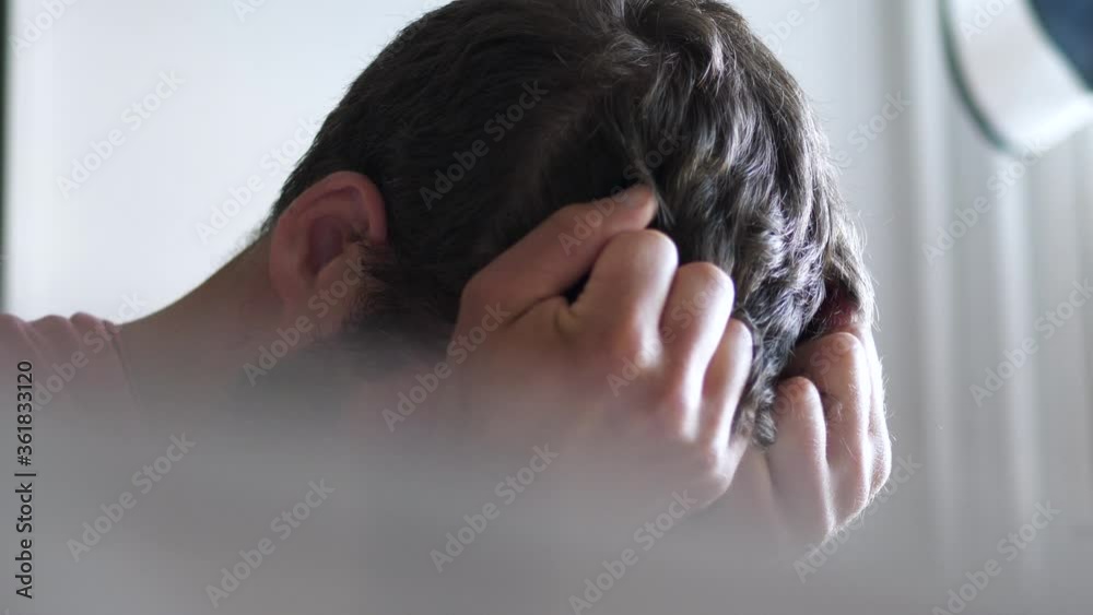 Desperate stressed man covers face in anxiety, depression concept