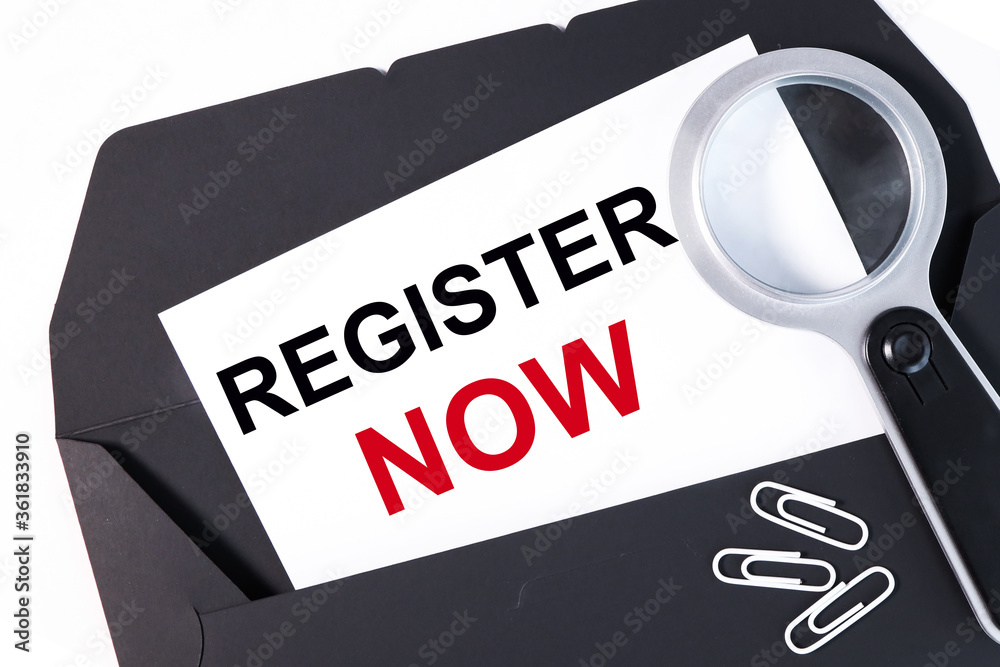 REGISTRATION NOW text on a business card on a black envelope. business concept REGISTRATION NOW text on a business card on a black envelope. business concept