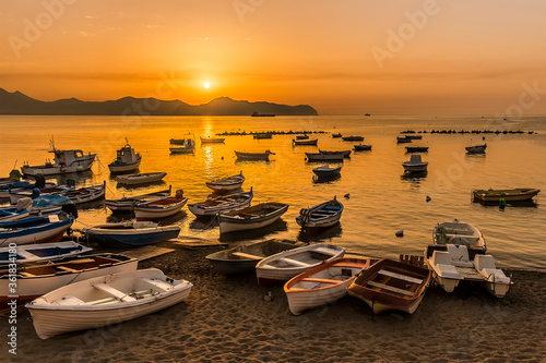 Fishing boats moored at Aspra Sicily as the sun goes down on a summer's evening photo