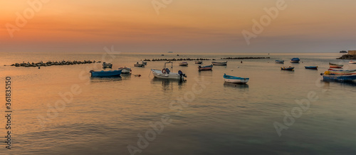 Wallpaper Mural Fishing boats inside the calm of the breakwater at Aspra Sicily at sunset on a summer's evening Torontodigital.ca
