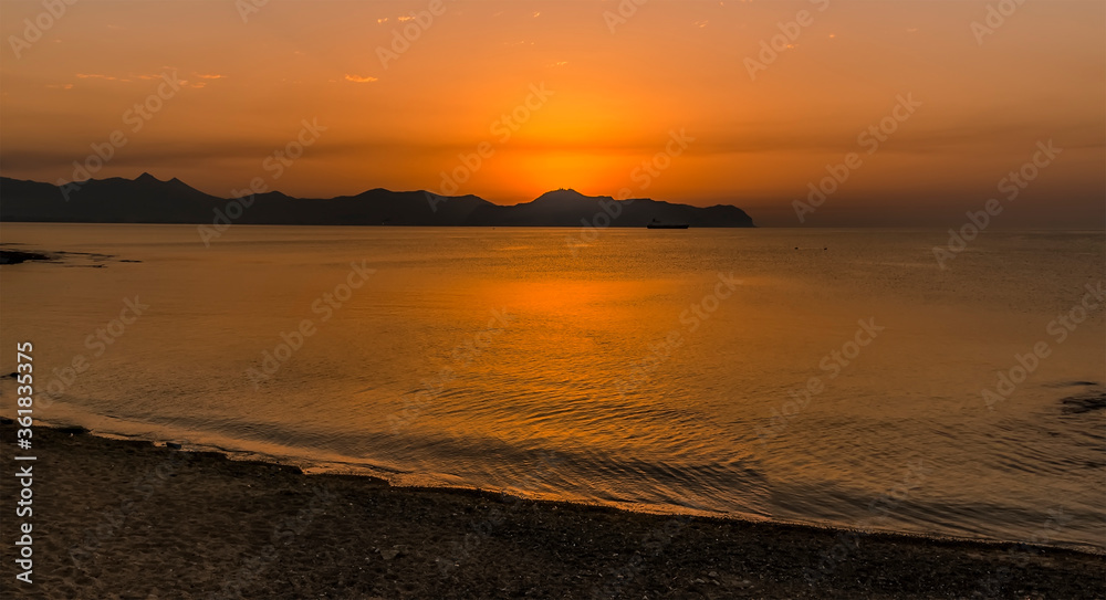 A orange sundowner at Aspra Sicily in the Gulf of Palermo on a summer's evening