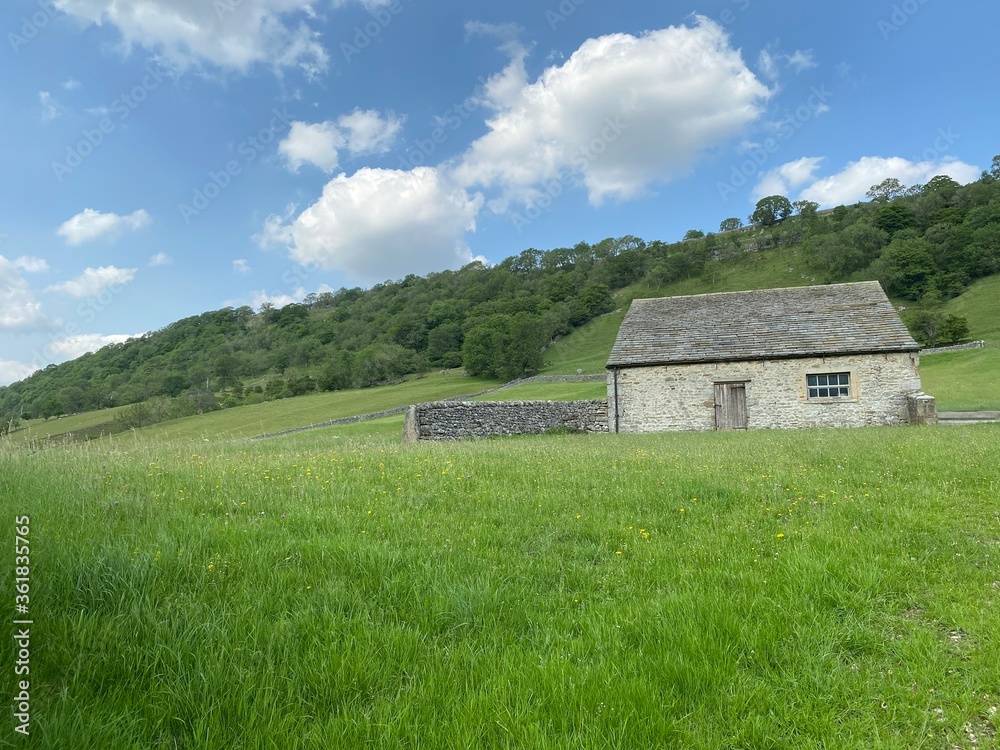 Farm building, set in a field with long grass in, Kettlewell, Skipton, UK