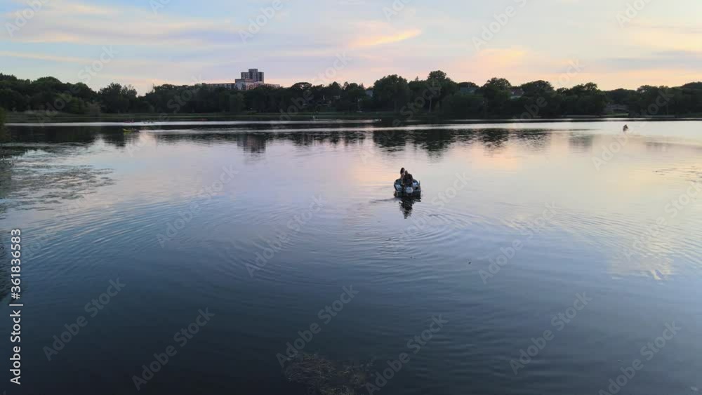 boat sailing in the lake during sunset with beautiful reflections on the water boat sailing in the lake during sunset with beautiful reflections on the water
