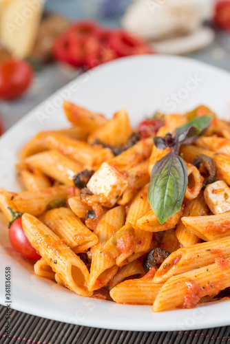 Wallpaper Mural Penne pasta in tomato sauce with chicken, tomatoes decorated with parsley Torontodigital.ca