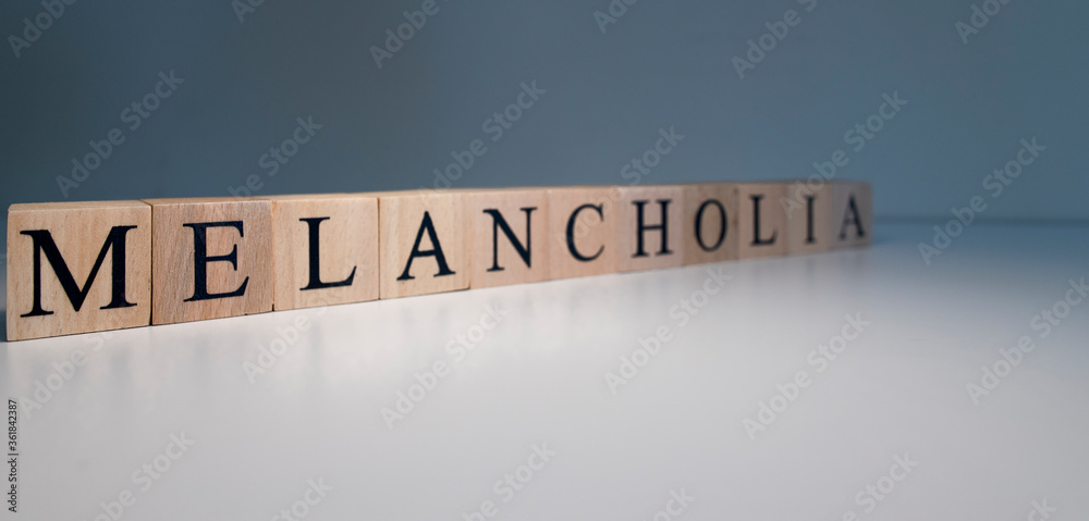 Fototapeta Text of melancholia from wooden cubes. psychological terms and health problems.