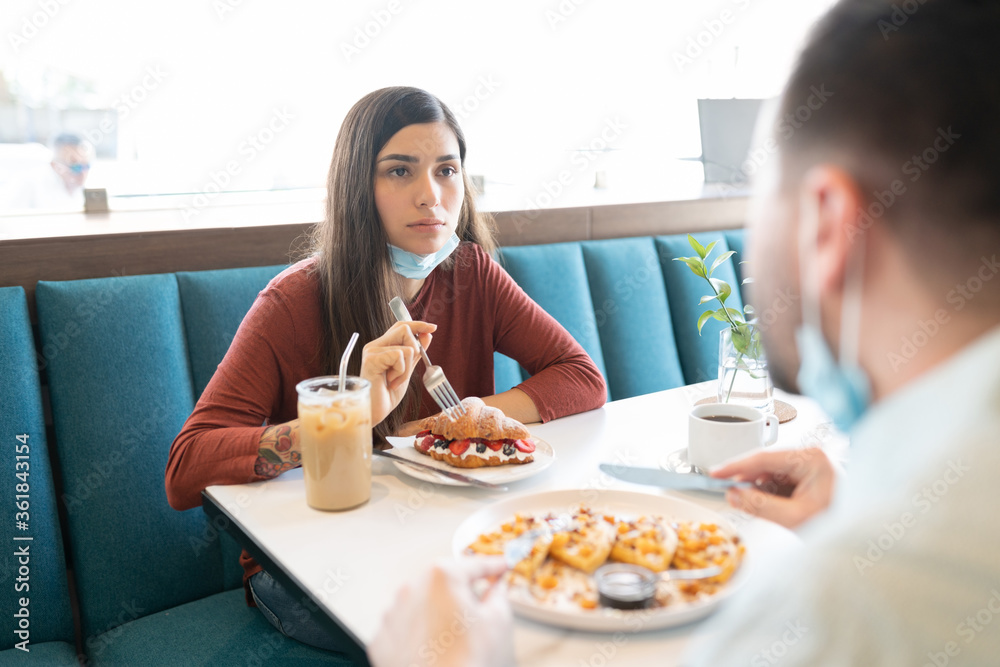 Couple Having Sweet Food In Restaurant