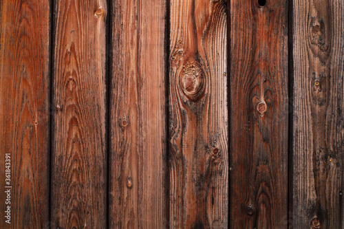 Wood texture. Old grey and orange boards with knots. Wood wallpaper. Wood background
