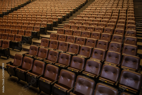 Theater or cinema auditorium with empty padded seats