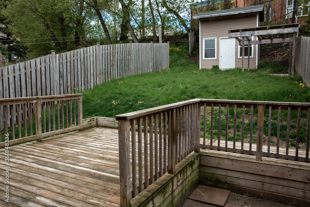 Wooden deck at the bottom of a green grass hill