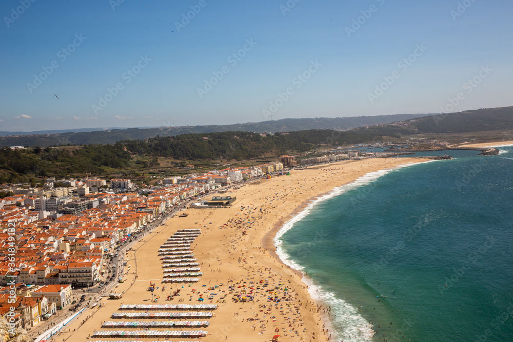 View of the beach ocean surf and town in Nazare Portugal