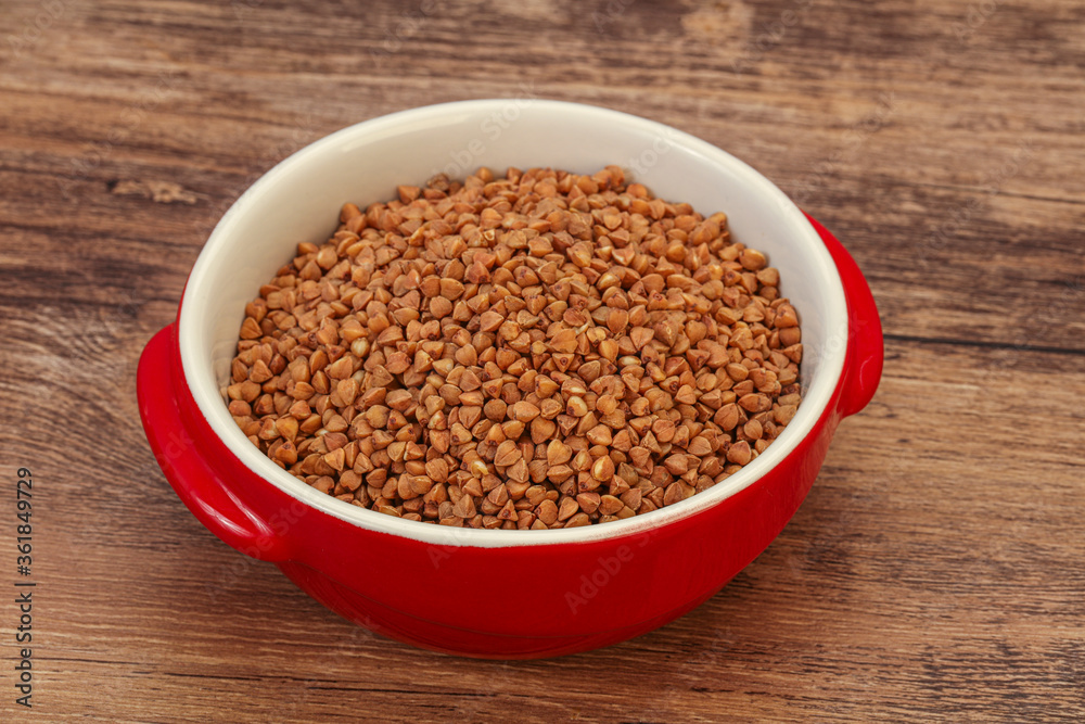 Raw buсkwheat cereal in the bowl Raw buсkwheat cereal in the bowl
