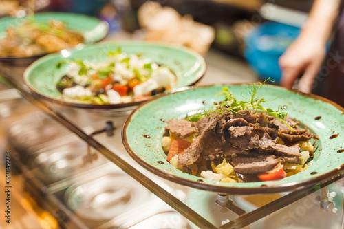 Salads in fast food restaurant according to social distance. Take away food in cafe in qarantine period. Healthy salads on the plates. photo