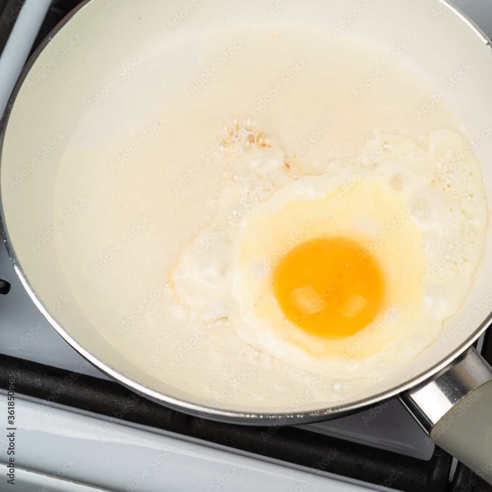 Egg fried in a pan with a white ceramic non-stick coating Egg fried in a pan with a white ceramic non-stick coating