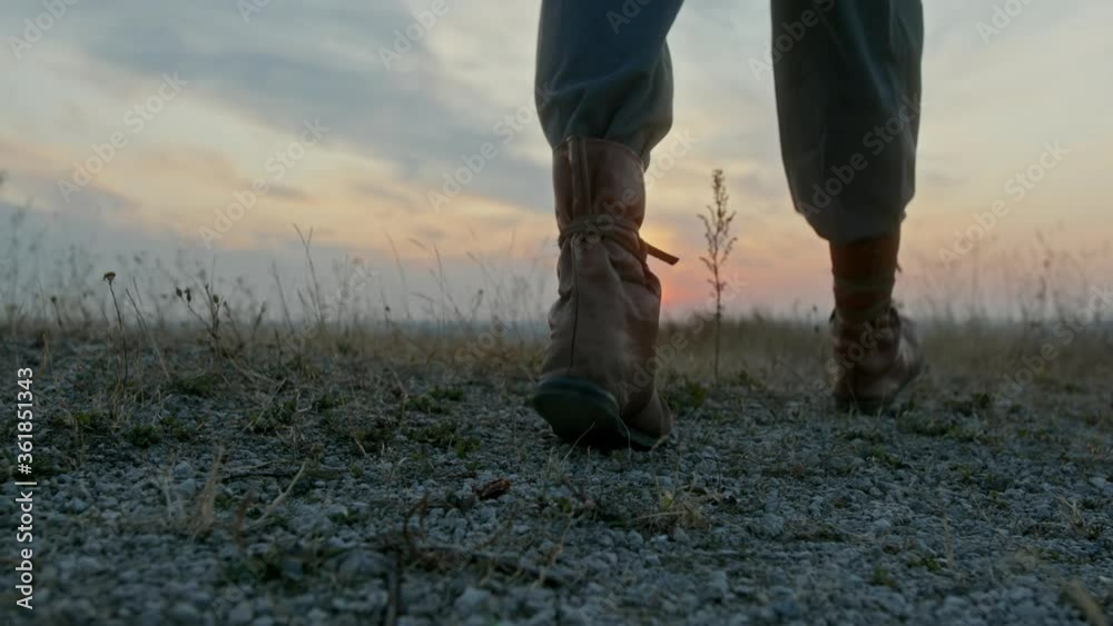 Man with sword wearing sheepskin at sunset Man with sword wearing sheepskin at sunset
