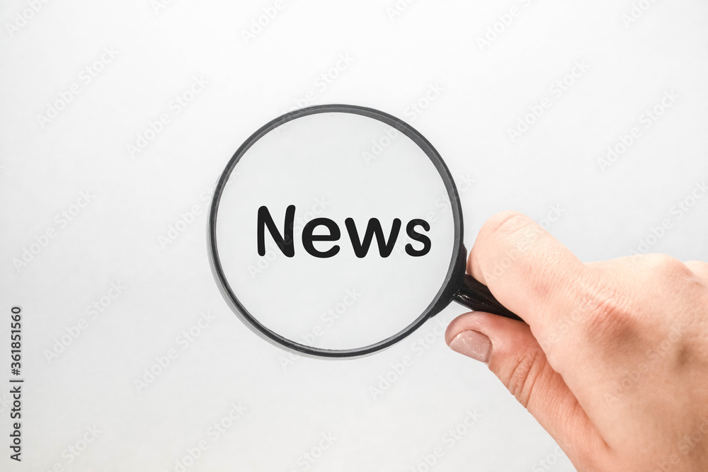 Word NEWS written in a magnifier on a white background. Word NEWS written in a magnifier on a white background.