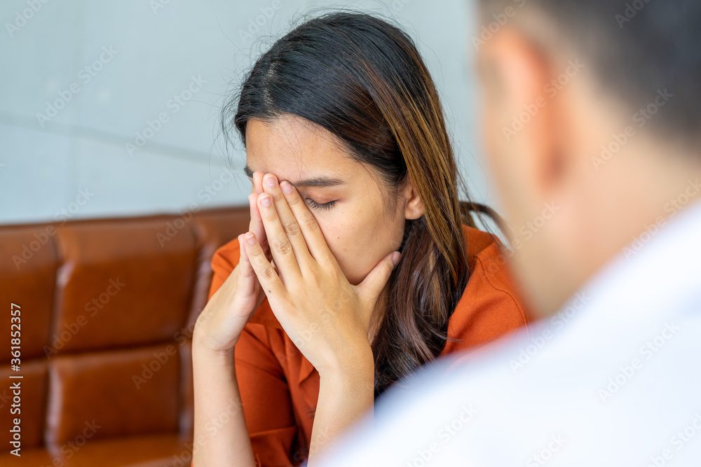 psychologist male consulting the mental health patient female sadly upset from covid-19 virus pandemic in the clinic office hospital psychologist male consulting the mental health patient female sadly upset from covid-19 virus pandemic in the clinic office hospital