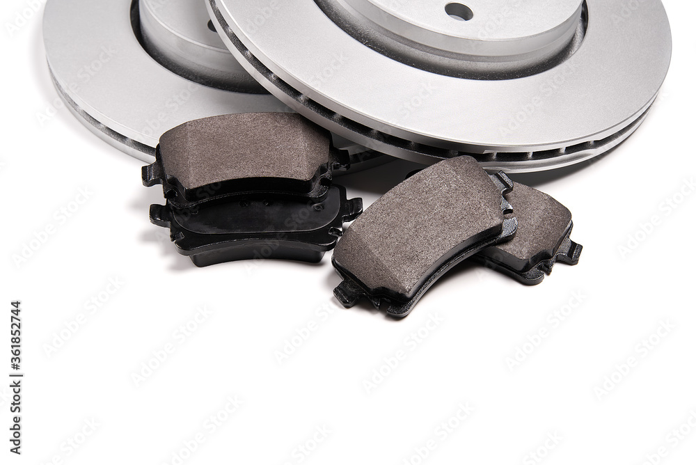 brand new brake discs and brake pad set for car. isolated on white with copy space. brand new brake discs and brake pad set for car. isolated on white with copy space.