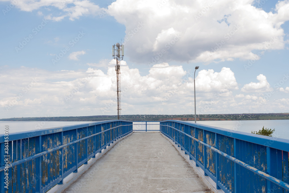 Fototapeta premium Old rusty blue foot bridge over the road.
