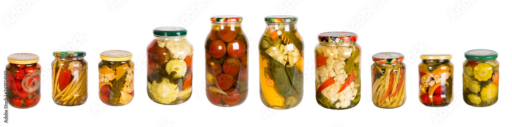 Set from of glass jars with canned vegetables on a white background. Panoramic. Isolated