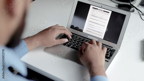 Hands of man typing on laptop, filling out job application form on screen. Day, closeup, cropped shot. Communication concept