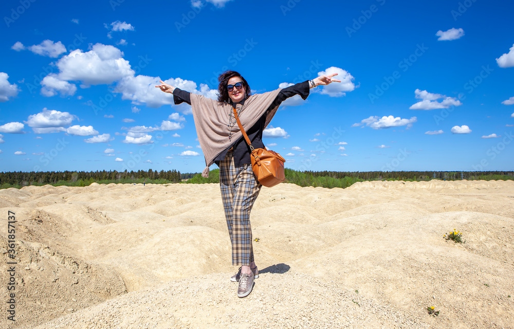Elegant woman on the background of the Martian landscape. Bornitsky quarry. The village of New Khinkolovo, Gatchinsky district, Leningrad region. Russia Elegant woman on the background of the Martian landscape. Bornitsky quarry. The village of New Khinkolovo, Gatchinsky district, Leningrad region. Russia