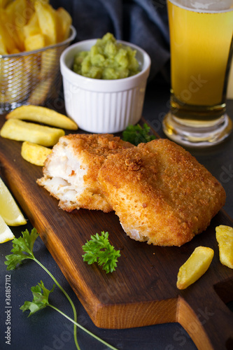 Photography Battered fish with french fries, mushy peas and sauce