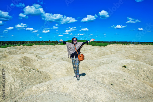 Elegant woman on the background of the Martian landscape. Bornitsky quarry. The village of New Khinkolovo, Gatchinsky district, Leningrad region. Russia photo