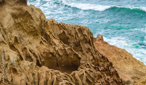 dramatic cliffs made from liquified sandstone overlooking the Pacific Ocean in San Diego, California USA photo