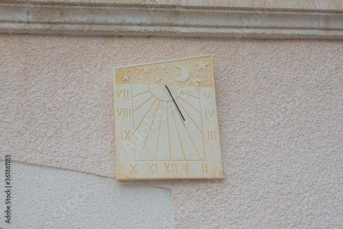 Ancient sundial on wall building in france