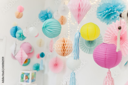 Party pom poms and paper lanterns. Cute party decorations. photo