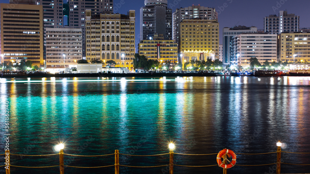 Fototapeta premium Long exposure landscape of old Dubai, UAE and the river and cruise light trails