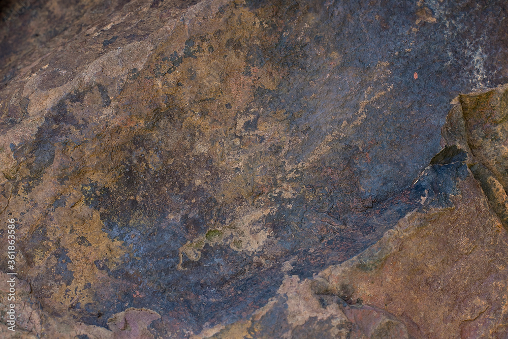 Background texture of a large ribbed stone of brown color Background texture of a large ribbed stone of brown color