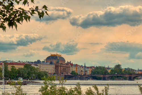 Prague National Theather from a distance under clouds on a sunny day of summer photo