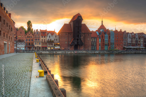Old town in Gdansk with historical port crane over Motlawa river at sunset, Poland.