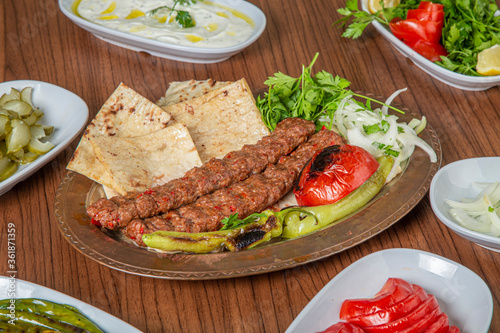 Turkish Adana Kebab Dinner on wooden background.