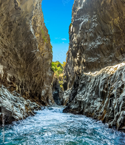 A panorama view of the river rapids and basalt column walls in the Alcantara gorge near Taormina, Sicily in summer photo
