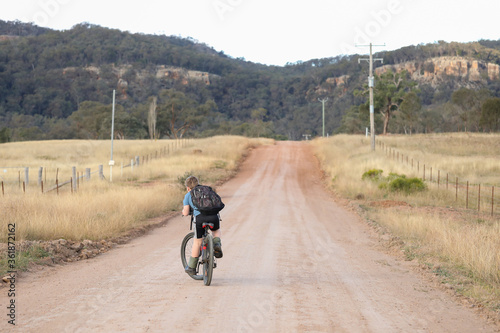 Children riding bikes on remote country lane