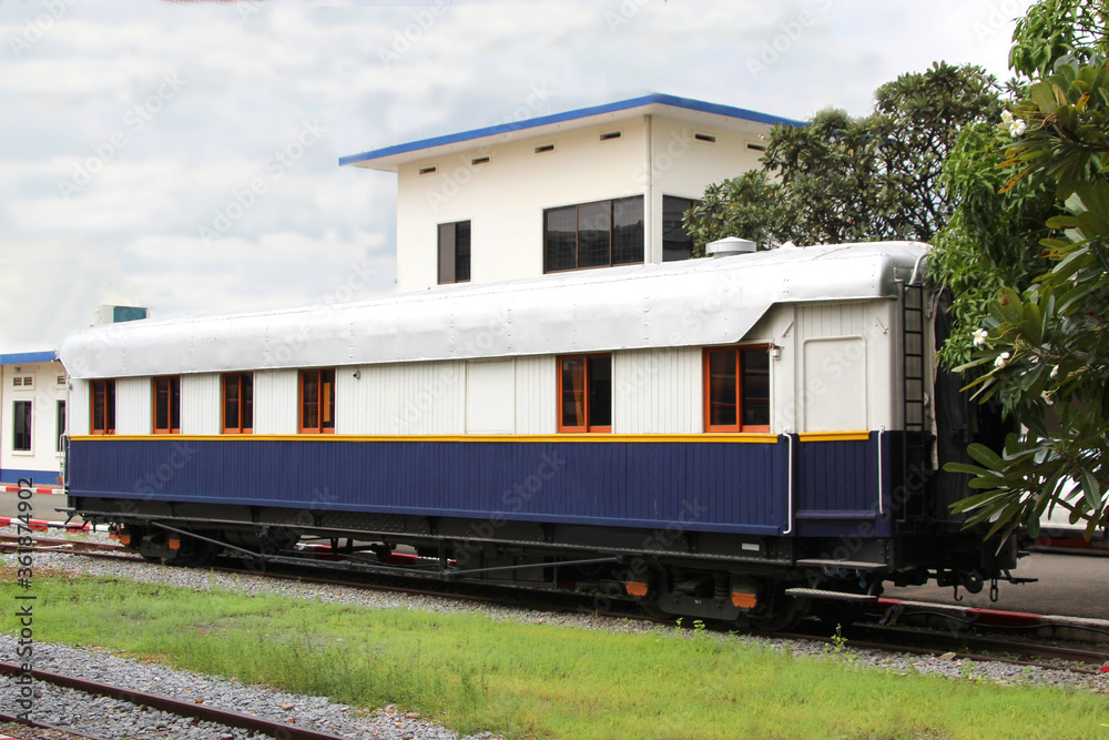 White and blue passenger wooden railway wagon at station White and blue passenger wooden railway wagon at station