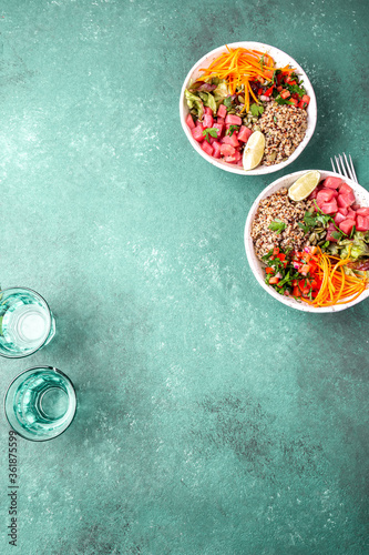 Vercion of Hawaiian tuna poke bowl with quinoa. tropical turquoise background photo