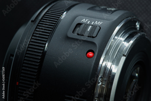 Macro closeup photo of lens to dslr camera on dark background photo