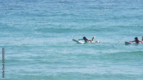 blur surfers with surfboard on the sea in sunny day