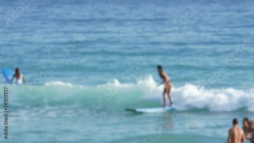 blur surfers with surfboard on the sea in sunny day