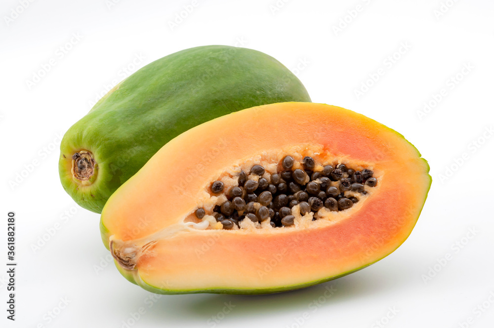 Vitamin rich exotic fruits concept with photograph of whole papaya and halved fruit isolated on black background with clipping path cutout Vitamin rich exotic fruits concept with photograph of whole papaya and halved fruit isolated on black background with clipping path cutout