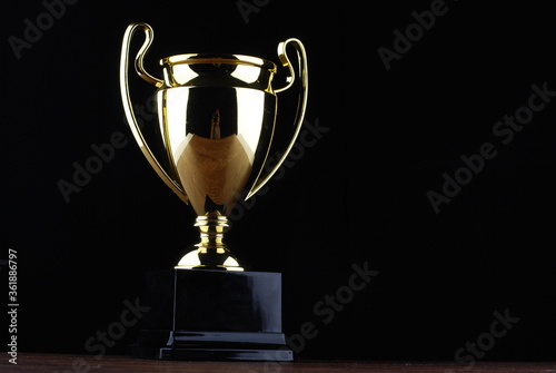 Golden trophy against black background