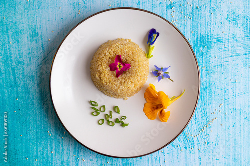 Quinoa plate presentation decorated with edible flowers