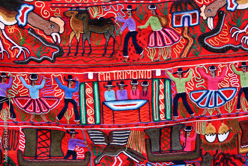 Woven and embroidered wall hanging on display for sale at tourist market in Peru